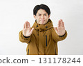 A man wearing a down jacket, posing in a restraining manner, white background 131178244