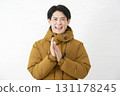 Man wearing down jacket clapping white background 131178245