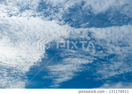 Autumn blue sky and cirrocumulus clouds with warm colors 131178911