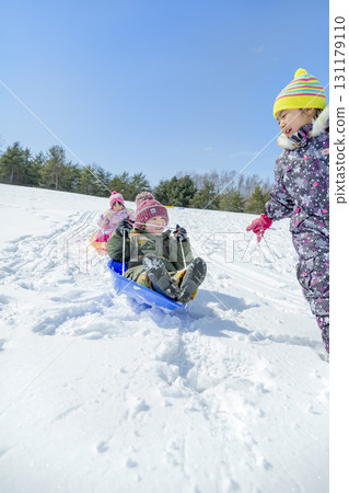 Children playing in the snow in the winter park Children playing in the snow in the winter park 131179110
