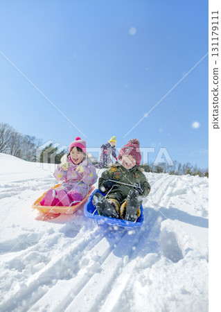 Children playing in the snow in the winter park 131179111