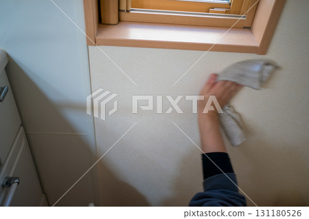 Housewife wiping the kitchen wall 131180526