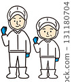 Middle-aged men and women working in a factory doing a fist pump 131180704