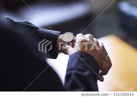 A senior man's hand points to the dial of his wristwatch. A senior man's hand points to the dial of his wristwatch. 131180814