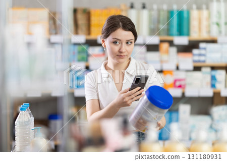 Young woman scanning qr code of baby formula 131180931