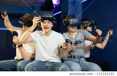 Excited teenager having fun with friends in virtual reality room 131181235