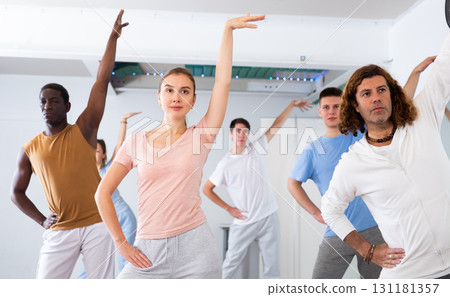 Group of happy young adult multinational sports people exercising dancing in modern gym studio 131181357