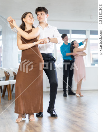 Latin American guy and girl performing kizomba in dance studio 131181368