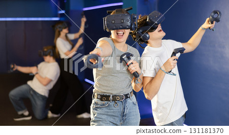 Portrait of young woman with virtual reality glasses standing in room Portrait of young woman with virtual reality glasses standing in room 131181370
