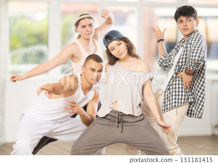 Young girl standing performs basic hip hop movements in front of group of students Young girl standing performs basic hip hop movements in front of group of students 131181415