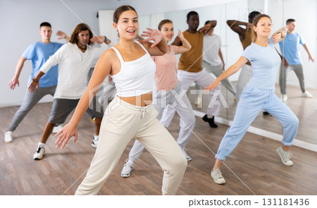 Group of different people rehearsing dance in dance studio Group of different people rehearsing dance in dance studio 131181436