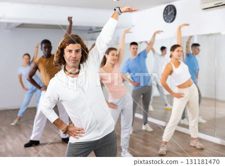 Group of women and men training sport dance in modern studio 131181470