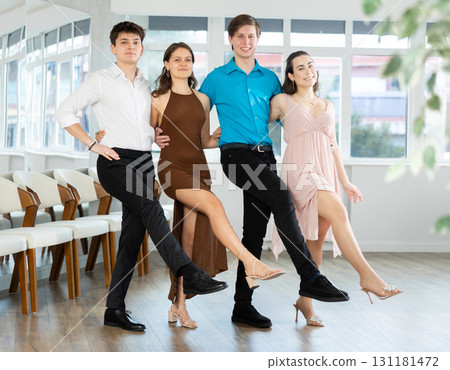 Cheerful young people performing can-can in dance studio Cheerful young people performing can-can in dance studio 131181472