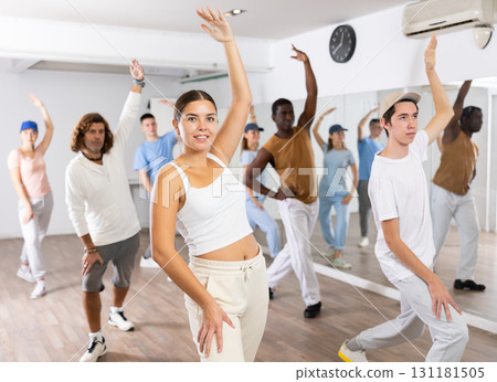Group of different people rehearsing dance in dance studio 131181505