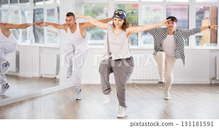 Young girl practicing hip hop reject step in training hall 131181591