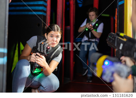 Young woman playing lasertag in arena 131181620
