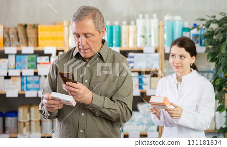 Senior man buys paracetamol pills at pharmacy, pharmacist in background Senior man buys paracetamol pills at pharmacy, pharmacist in background 131181834