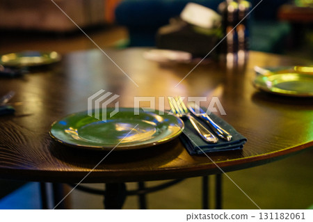 Restaurant plates dining: Table set for dinner with plates and silverware in upscale restaurant tonight. Restaurant plates dining: Table set for dinner with plates and silverware in upscale restaurant tonight. 131182061