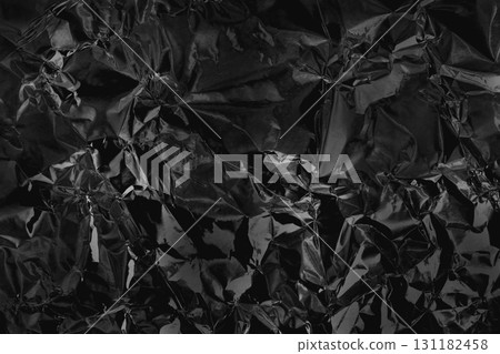 Shiny black grey foil metal texture, abstract wrapping paper for background and design art work. Shiny black grey foil metal texture, abstract wrapping paper for background and design art work. 131182458