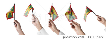 The Grenada flag in hand in different angles on a white background 131182477