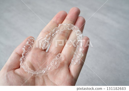 Image of a person holding an orthodontic retainer Image of a person holding an orthodontic retainer 131182683