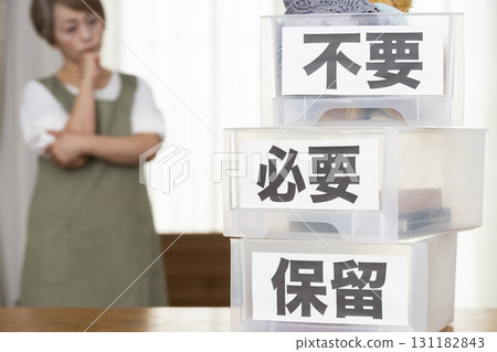 Senior woman decluttering in the living room Senior woman decluttering in the living room 131182843