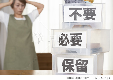 Senior woman decluttering in the living room Senior woman decluttering in the living room 131182845