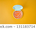 Orange and white case containing orthodontic aligners 131183714