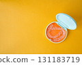 Orange and white case containing orthodontic aligners 131183719