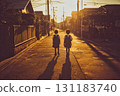 兩名小學生在黃昏時分走在學校的路上，他們的影子延伸開來 131183740