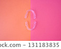 Orthodontic aligners and orange and pink background 131183835