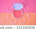 Orthodontic aligners and cases on orange and pink background 131183836