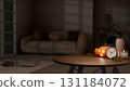 Glowing halloween pumpkin lantern with clock and lighting candle on wooden table in dark living room 131184072