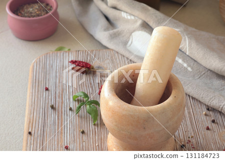 Marble mortar in kitchen. Food and cooking. Healthy eating and organic products. Marble mortar in kitchen. Food and cooking. Healthy eating and organic products. 131184723