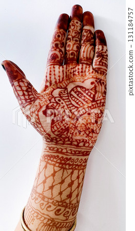 Beautiful Indian female hands with henna tattoo isolated on white background Beautiful Indian female hands with henna tattoo isolated on white background 131184757
