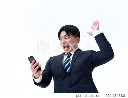Young businessman looking at smartphone Young businessman looking at smartphone 131184880
