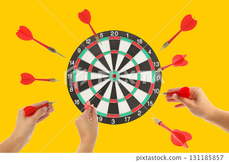 Darts are thrown with precision aiming at the dartboard 131185857