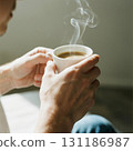 Man Holding a Steaming Cup of Coffee 131186987