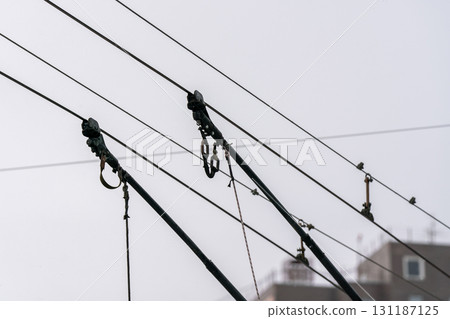 Trolleybus current collectors against a cloudy sky. Trolleybus current collectors against a cloudy sky. 131187125