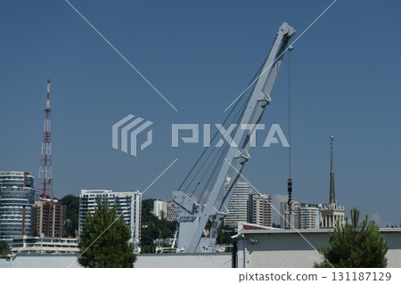 A tall metal crane for launching boats into the water. 131187129