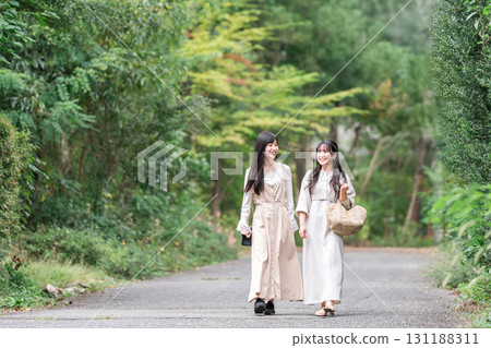 Young Asian woman walking through a tourist spot (girls' trip, travel, tourism) 131188311