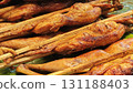 Thai grilled chicken on a rotisserie. 131188403
