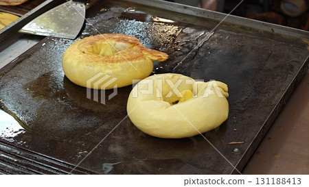 Fried roti in hot pan. Fried roti in hot pan. 131188413