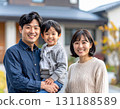 Family posing in front of their home 131188589