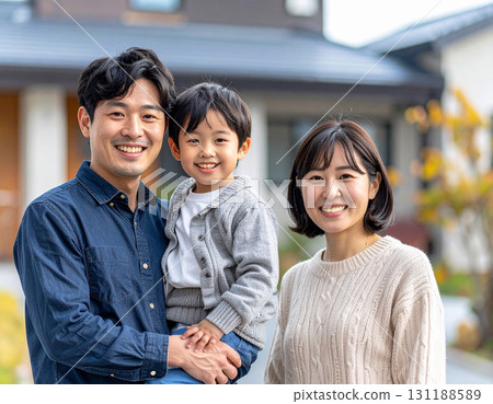 Family posing in front of their home 131188589