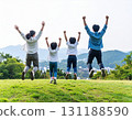 Family jumping on a hill 131188590