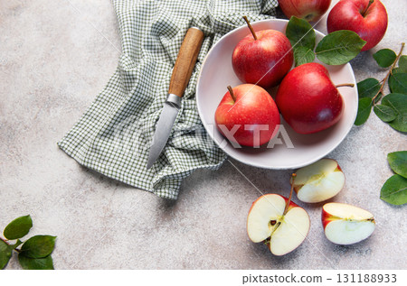 Fresh red apples in bowl with knife 131188933