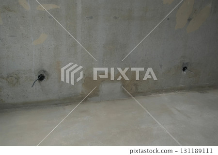 Electric wires in room sticking out of cement wall in rough repairs apartment. 131189111