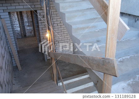 Staircase of multi-storey building under construction with brick walls. Staircase of multi-storey building under construction with brick walls. 131189128