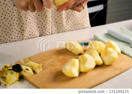 Woman peeling cutting apples cooking dish on kitchen at home, hands close-up. Woman peeling cutting apples cooking dish on kitchen at home, hands close-up. 131189225